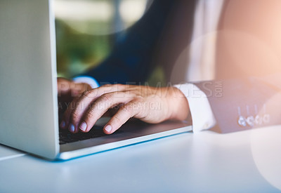 Buy stock photo Closeup shot of an unidentifiable businessman working on a laptop in an office