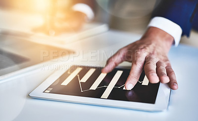 Buy stock photo Closeup shot of an unidentifiable businessman working on a digital tablet in an office