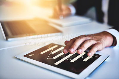 Buy stock photo Closeup shot of an unidentifiable businessman working on a digital tablet in an office