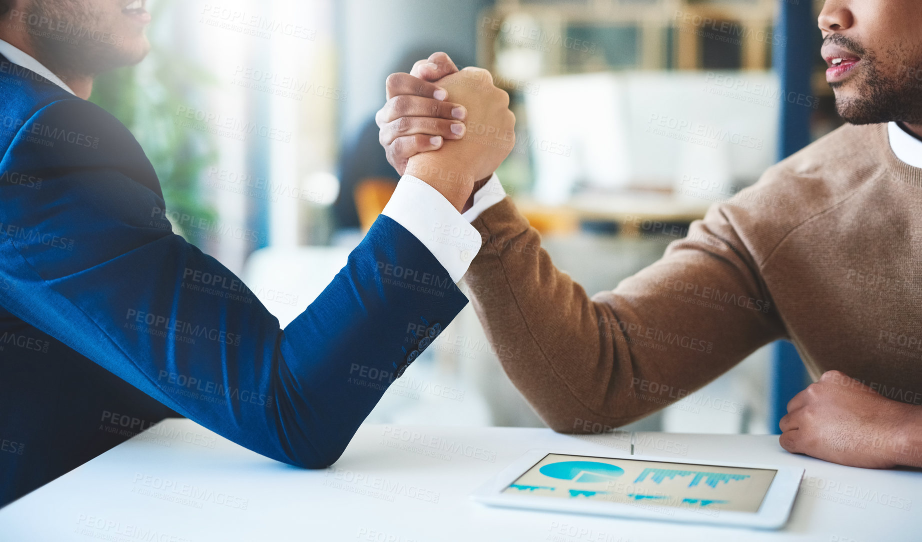 Buy stock photo Hands, competition and arm wrestling with tablet in office for challenge, teamwork and handshake. Male people, employees and tech for collaboration in financial agency, investment banking or business