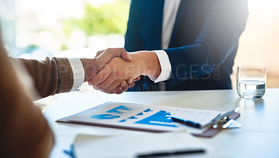 Buy stock photo Closeup shot of two unidentifiable businessmen shaking hands in an office