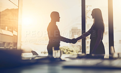 Buy stock photo Cropped shot of businesspeople shaking hands in an office