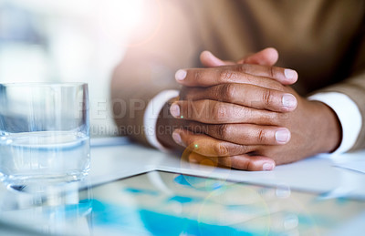 Buy stock photo Closeup shot of an unidentifiable businessman sitting with his hands clasped in an office