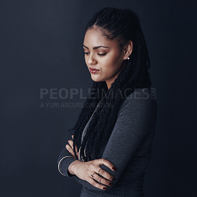 Buy stock photo Studio shot of a young woman posing against a gray background