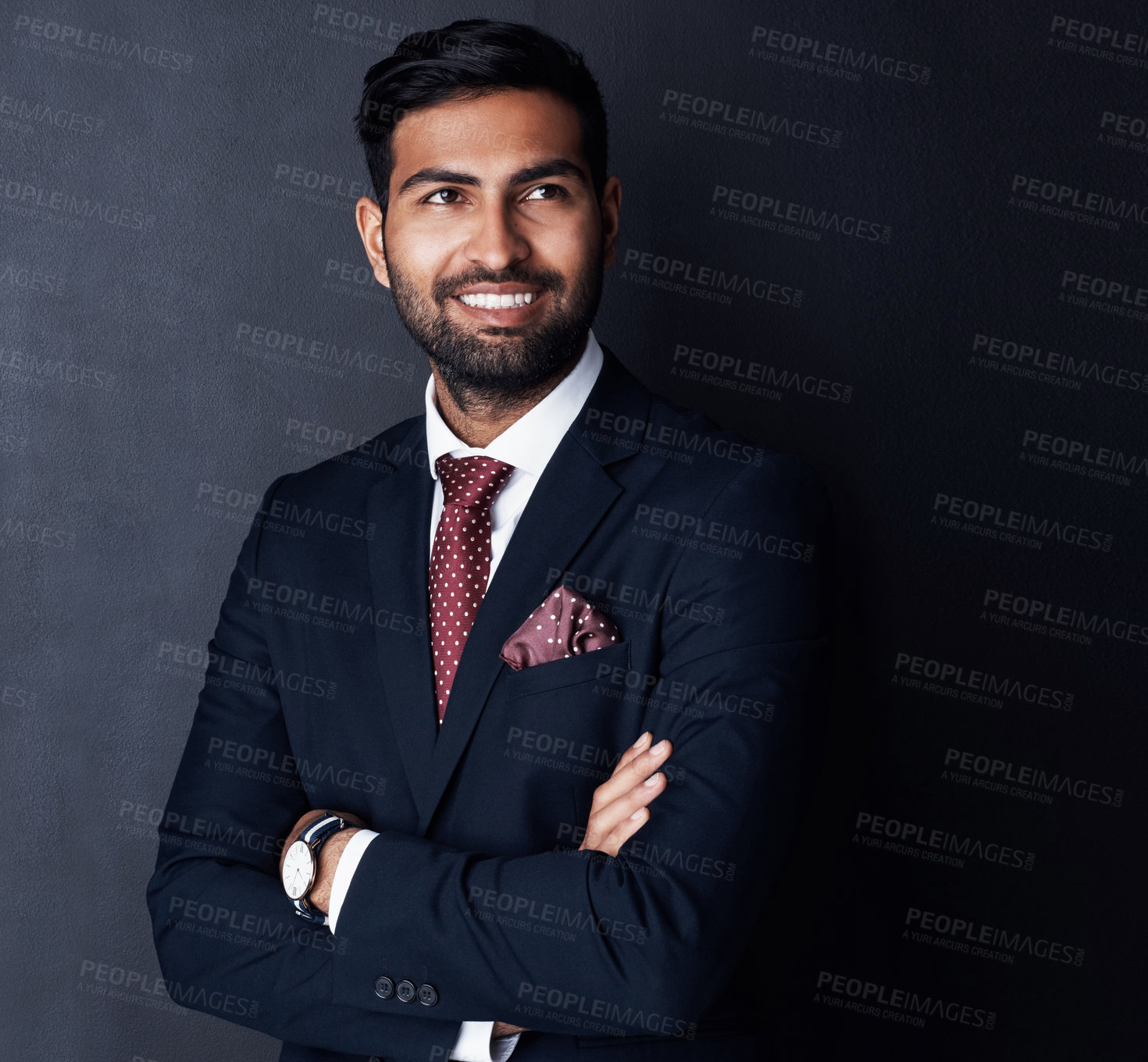 Buy stock photo Studio shot of a confident young businessman posing against a gray background