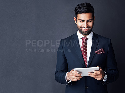 Buy stock photo Happy, business man and tablet on dark background in studio with mockup space for trading, planning and internet research. Corporate, indian male trader and smile for digital technology of online app