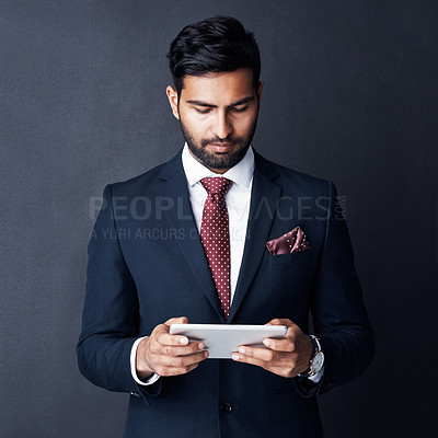 Buy stock photo Business man, tablet and dark background for trading online, planning stock market research and corporate data in studio. Serious trader, indian male person and digital technology for website on app