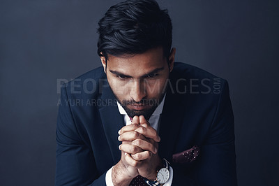 Buy stock photo Studio shot of a businessman looking worried against a gray background