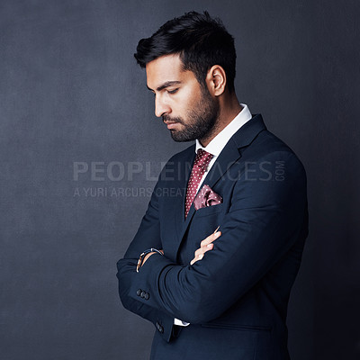 Buy stock photo Studio shot of a businessman looking down against a gray background