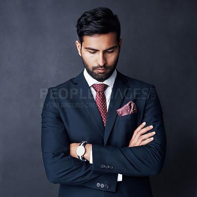Buy stock photo Studio shot of a businessman looking down against a gray background