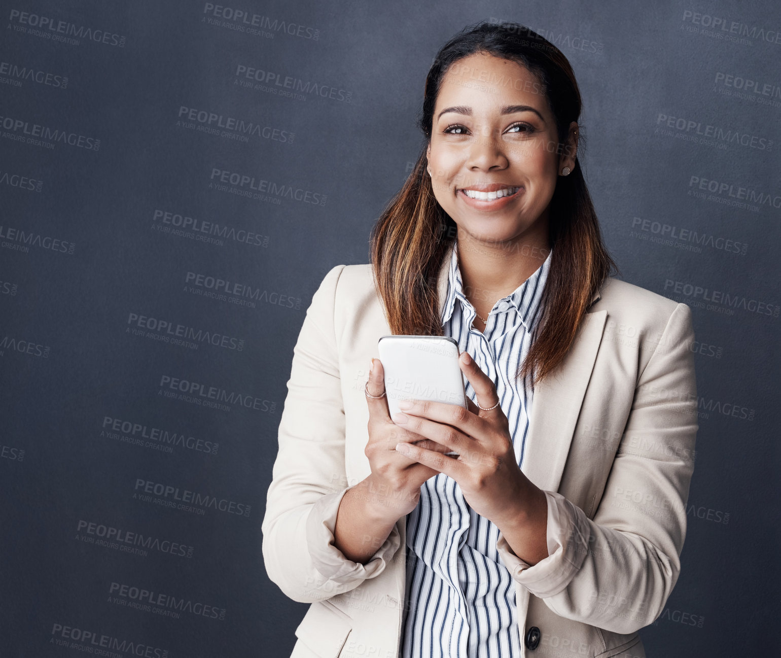 Buy stock photo Business woman, smartphone and portrait in studio for notification, texting pr happy by dark background. Person, phone and scroll on mobile app for chat on web, networking or social media in Colombia