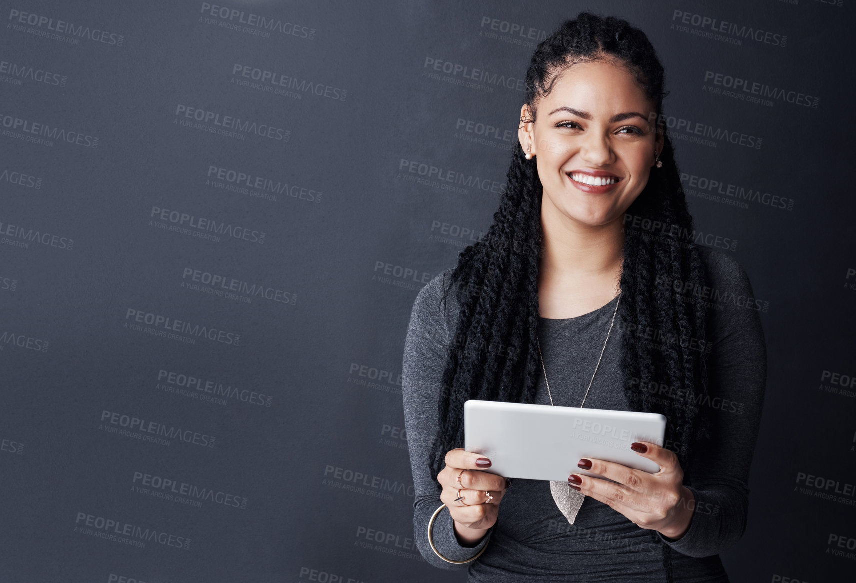 Buy stock photo Happy woman, portrait and business with tablet on space for research, network or connectivity on a gray studio background. Female person, user or model with smile or technology for app on mockup