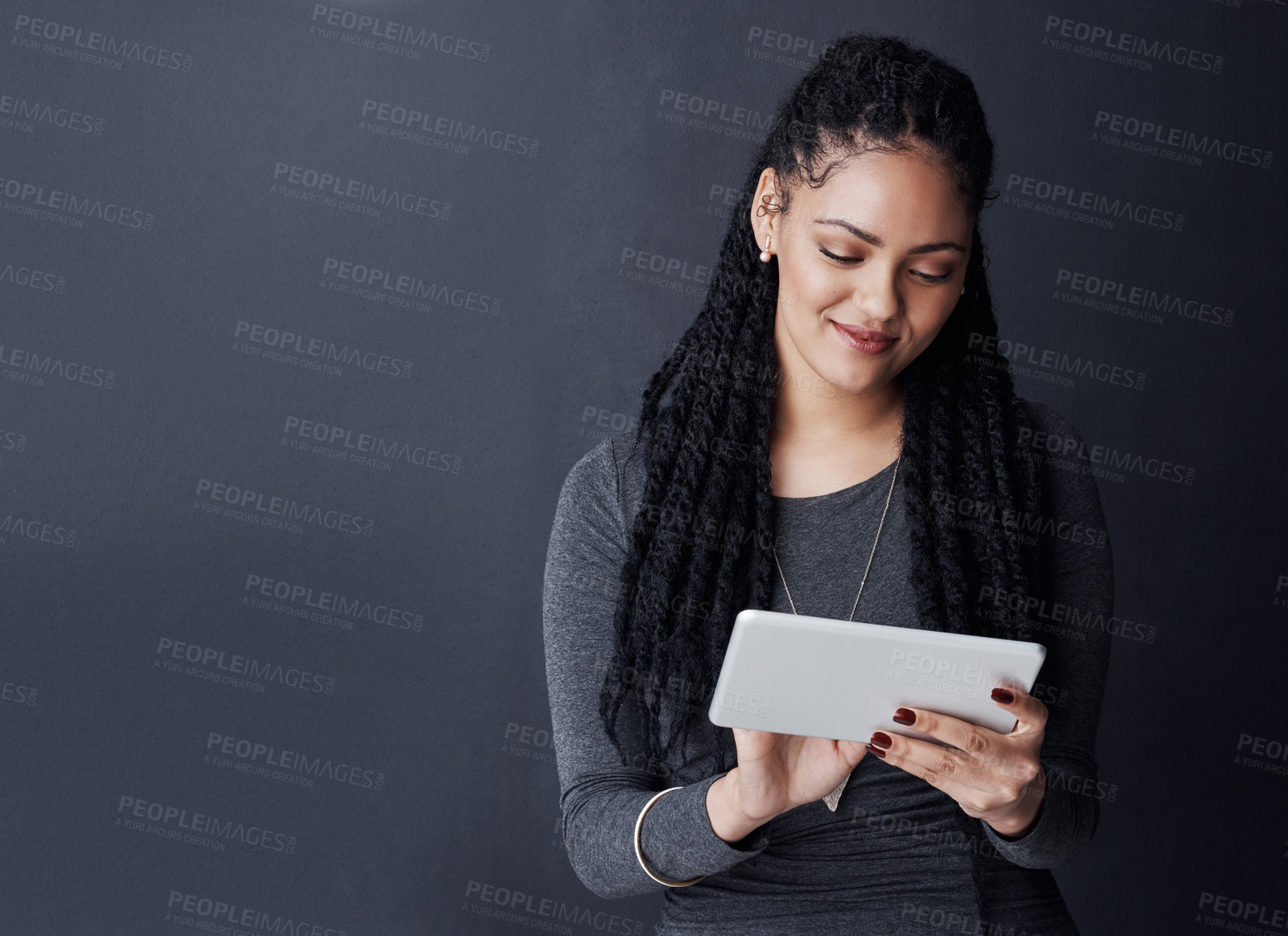 Buy stock photo Studio, smile and woman with scroll for tablet, reading blog and news story for business journalist. African person, happy and editor with research for publication, mockup space or dark background