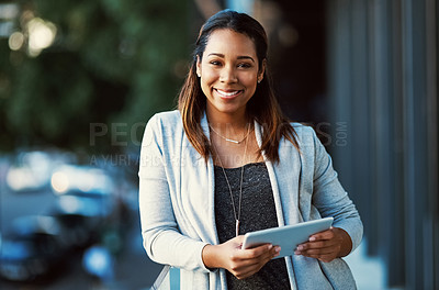 Buy stock photo Portrait of a businesswoman using her tablet while standing outside on the balcony