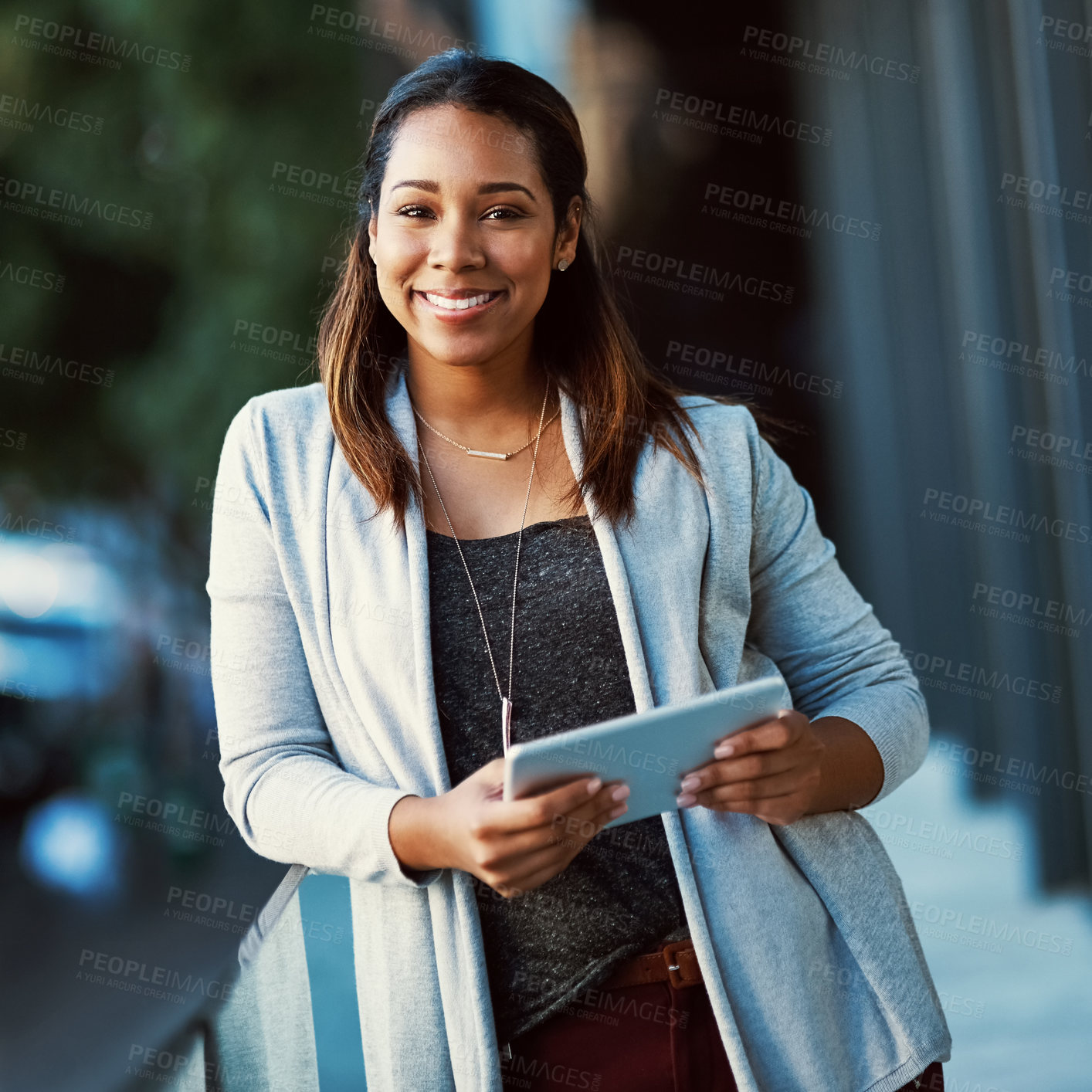 Buy stock photo Portrait of a businesswoman using her tablet while standing outside on the balcony