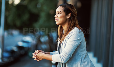 Buy stock photo Shot of an attractive young businesswoman standing on her office balcony
