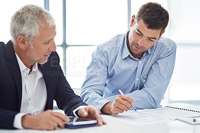 Buy stock photo Cropped shot of two businessmen working together in the office