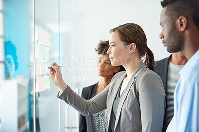 Buy stock photo Glass wall, business people and brainstorming with ideas, writing and productivity in modern office. Startup, group and employees in meeting, seo or collaboration with planning for project or support