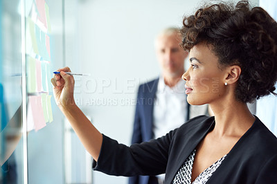 Buy stock photo Shot of businesspeople having a brainstorming session at work