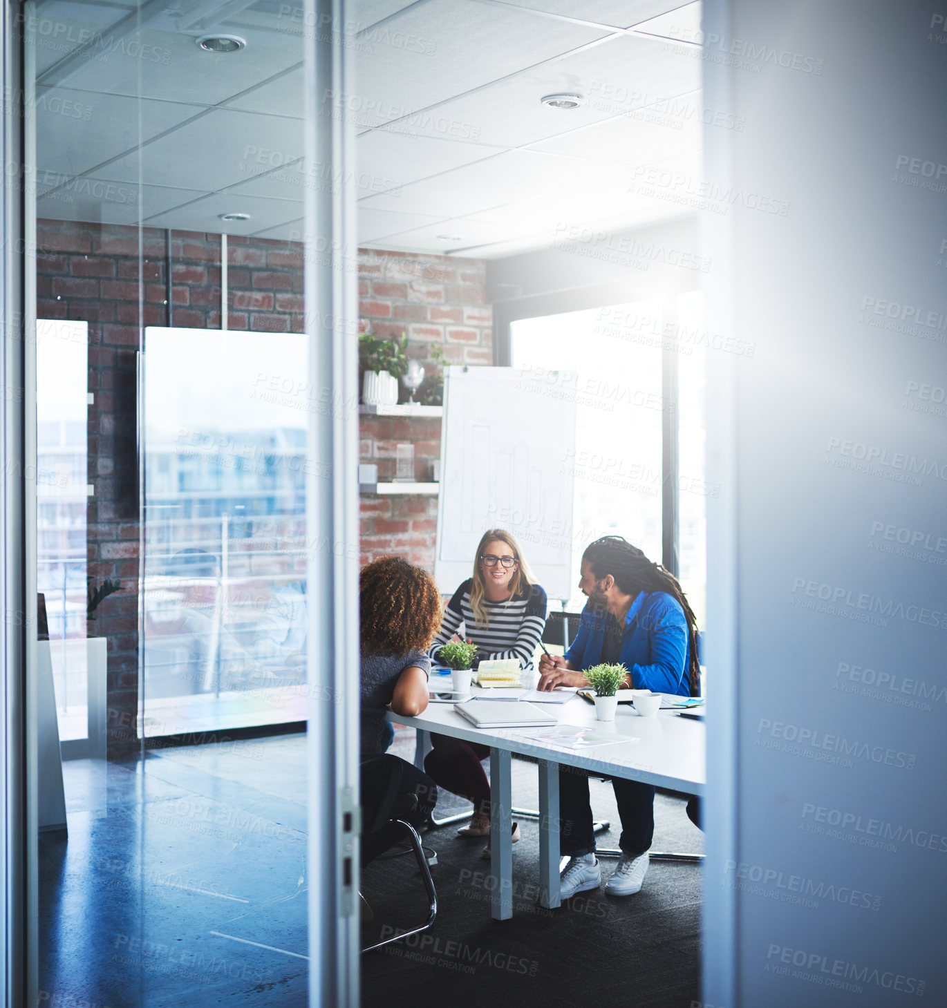 Buy stock photo Shot of a group of designers having a meeting in an office