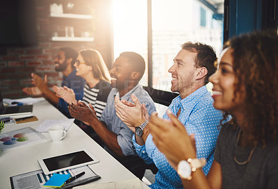 Buy stock photo Cropped shot of a group of businesspeople applauding a presentation in an office