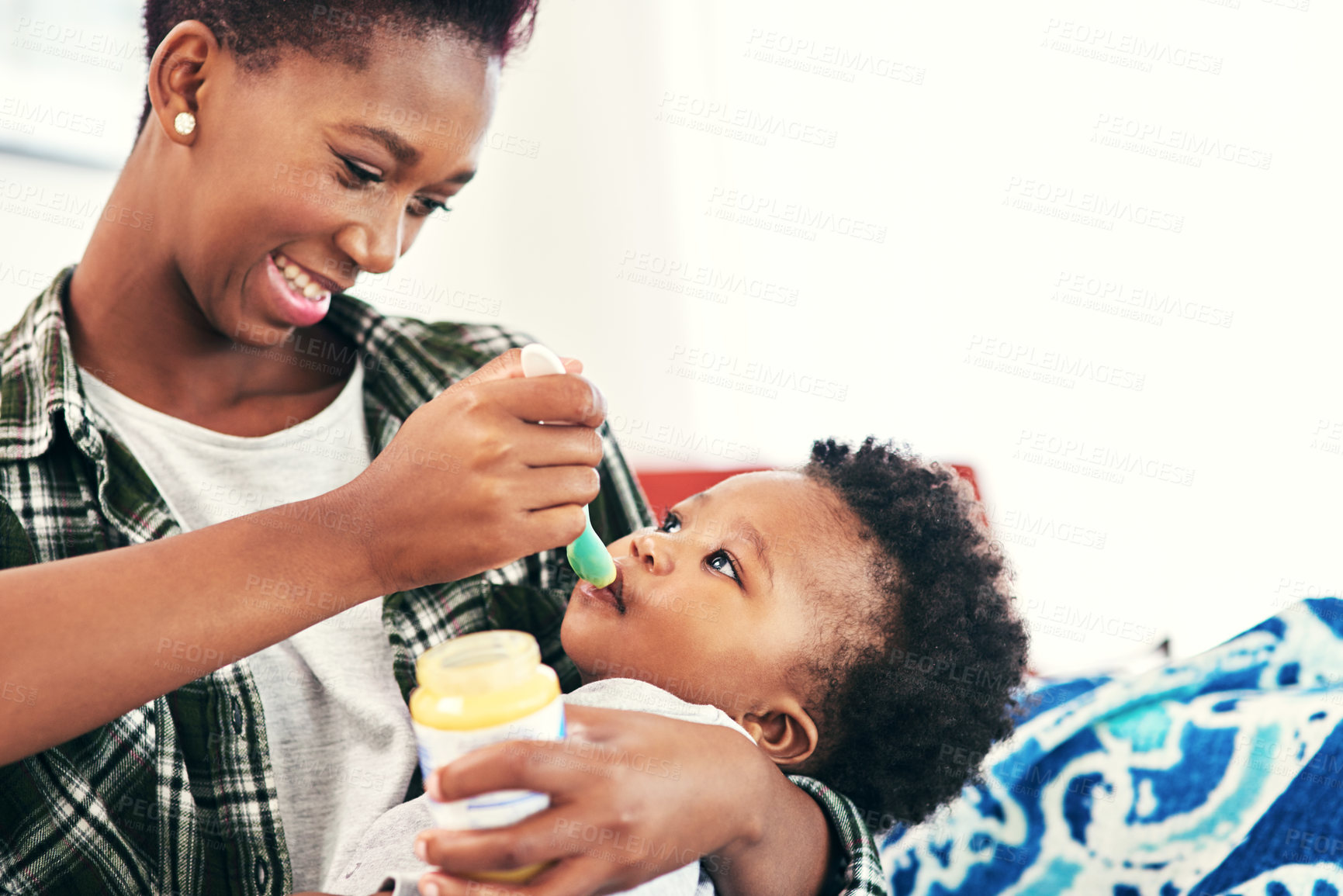 Buy stock photo Mom, baby and smile in home with feeding for nutrition, vitamins and growth for child development. Black people, parent and kid or toddler with meal for bonding or care, support and happy with trust