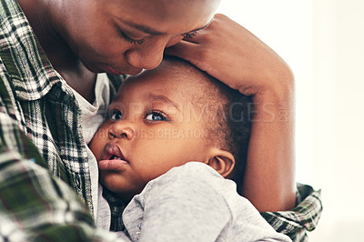 Buy stock photo Cropped shot of a young mother cradling her baby boy
