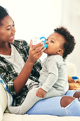 Buy stock photo Mother, feed and baby drinking bottle for nutrition or nourishment, weight gain and healthcare for growth or development. Parent, boy infant and nursing with rooibos tea for soothing before bedtime.