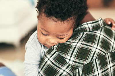 Buy stock photo Shot of an adorable baby boy falling asleep on his mother's shoulders