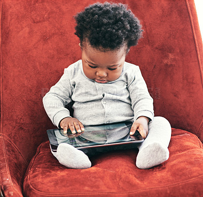 Buy stock photo Baby, boy and online with tablet in home with digital learning for early childhood or cognitive development and growth. Toddler, technology and relax on sofa with sensory app or game for motor skills