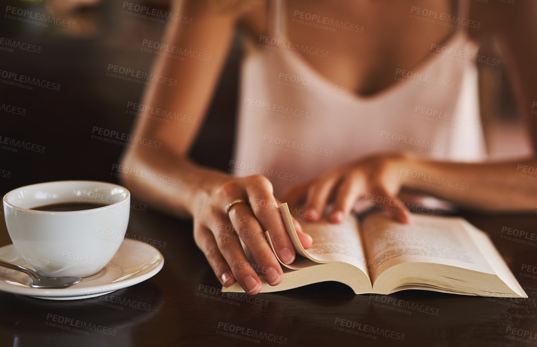 Buy stock photo Hands, student and reading book in coffee shop for story, knowledge and person learning literature information in university. Closeup, education and studying novel on cafe table at college with drink