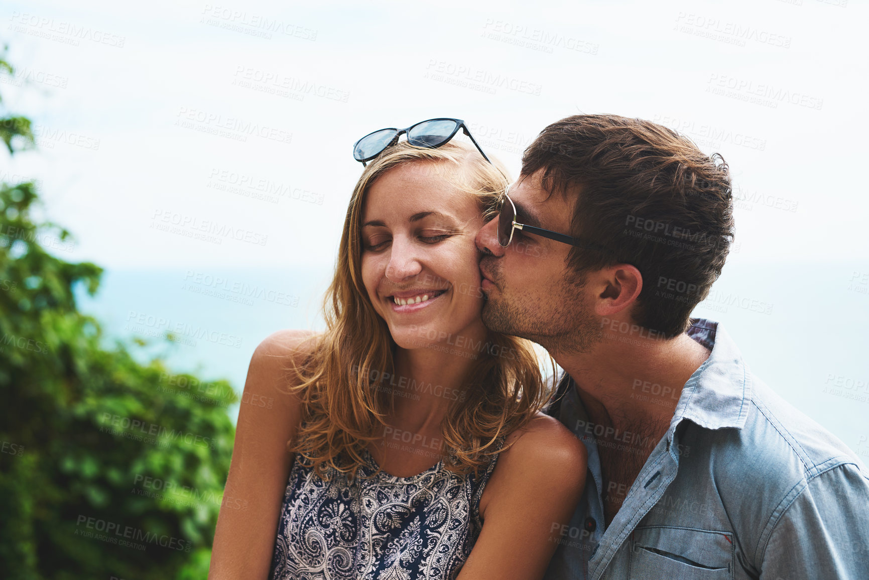 Buy stock photo Shot of a happy young couple spending time together outdoors