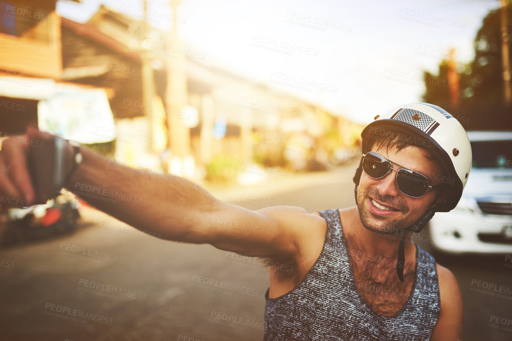 Buy stock photo Shot of a young man taking a selfie while out on his scooter