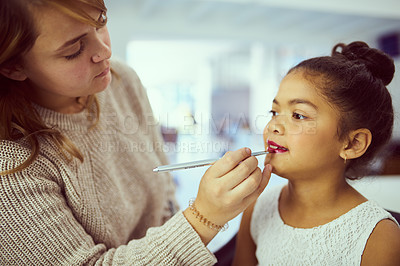 Buy stock photo Shot of a stylist applying makeup to a cute little girl in a dressing room