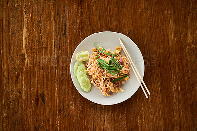 Buy stock photo Chinese cuisine, food and plate with chopsticks for eat with chicken, noodles and spring onion dish. Cooking, seafood and authentic stir fry for Asian culture on wooden table in restaurant with herb