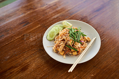 Buy stock photo Plate, food and Chinese cuisine with chopsticks for eat with chicken, noodles and spring onion dish. Cooking, lunch and authentic stir fry for Asian culture on wooden table with herbs or spices.