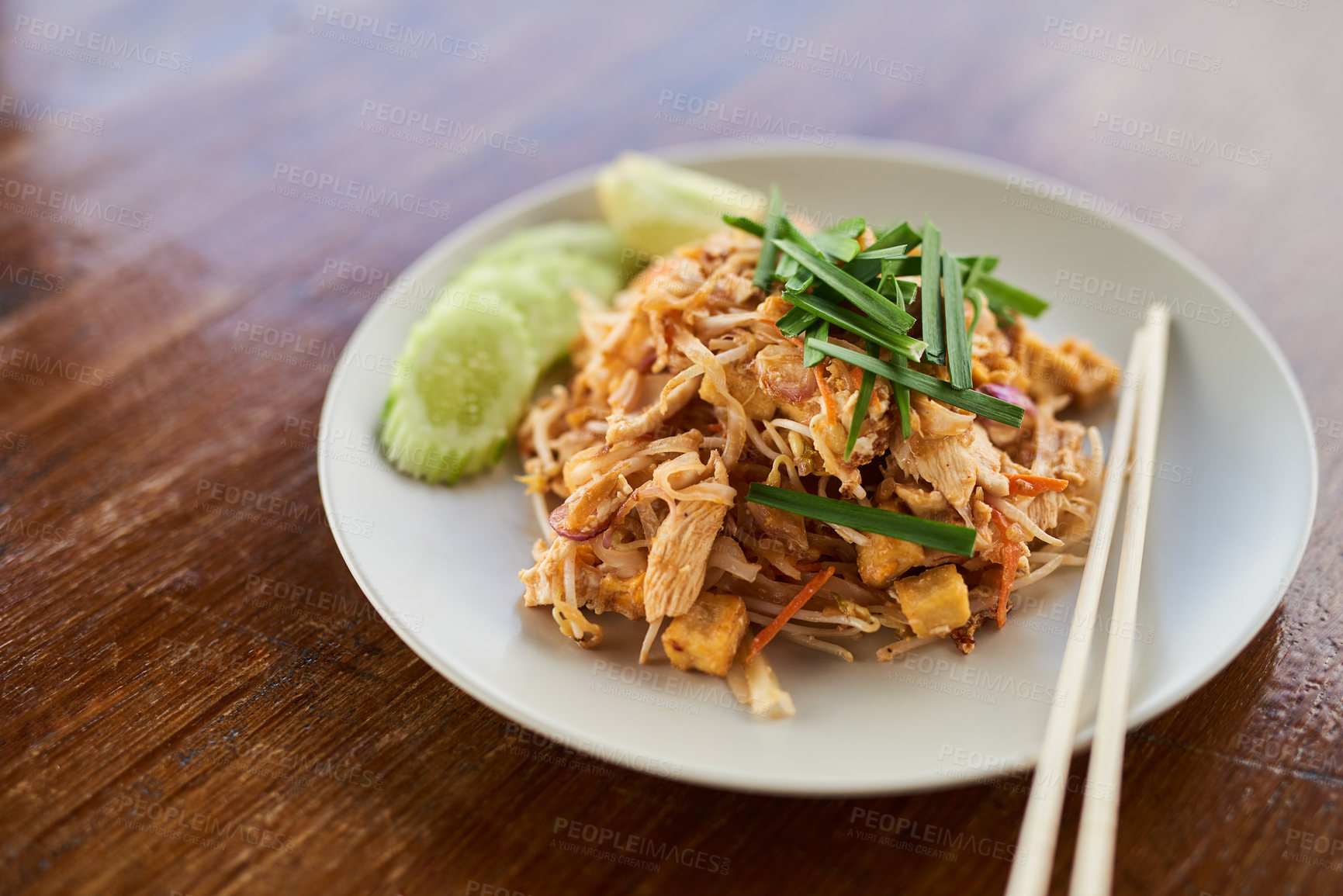 Buy stock photo Closeup shot of Chinese food on a plate on a wooden table