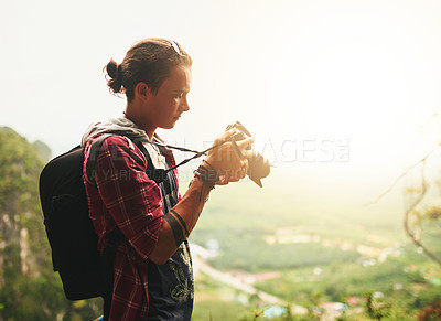 Buy stock photo Cropped shot of a young tourist taking photos while on vacation