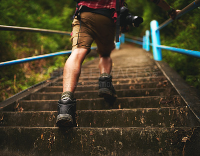 Buy stock photo Rearview shot of a man climbing stairs while hiking in the mountains