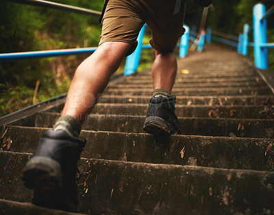 Buy stock photo Rearview shot of a man climbing stairs while hiking in the mountains