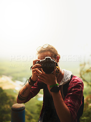 Buy stock photo Portrait of a young man taking a photo with his camera outside