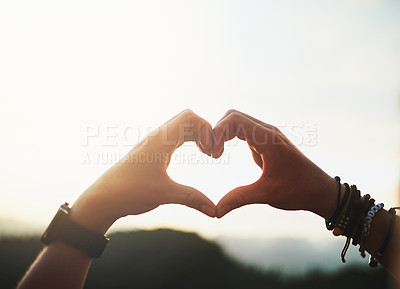 Buy stock photo Closeup shot of an unidentifiable man making a heart shape with his hands outside