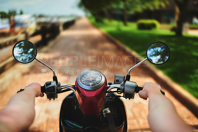 Buy stock photo Point of view shot of a young woman's hands as she rides a scooter