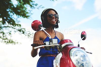 Buy stock photo Shot of a happy young woman out for a scooter ride on her own