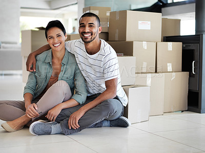 Buy stock photo Portrait of a happy young couple sitting on their living room floor on moving day