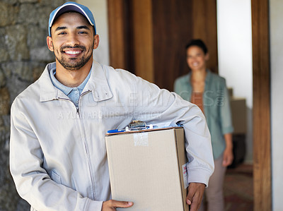 Buy stock photo Portrait of a smiling young courier carrying a package with a customer standing at her front door in the background