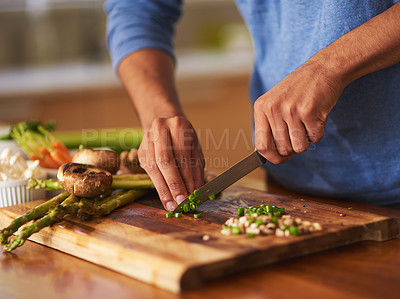 Buy stock photo Cropped shot of a man preparing a healthy meal at home