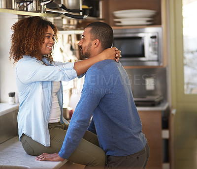 Buy stock photo Shot of a young couple sharing a romantic moment in the kitchen