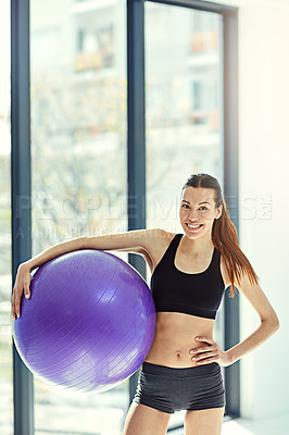 Buy stock photo Portrait of an attractive young woman working out with an exercise ball at home