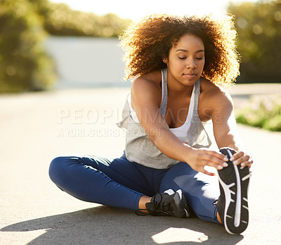 Buy stock photo Shot of an attractive young woman warming up before her workout
